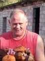 У саоего дома, примыкающего к лесу.