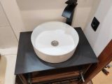 Замена и установка тумбы и раковины с столешницей из керамики с подключением сантехники.